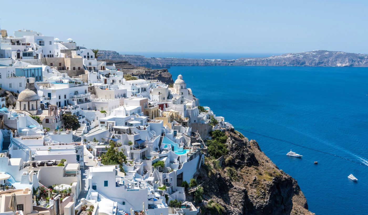 Beautiful Santorini houses overlooking the Aegean Sea on a sunny day.